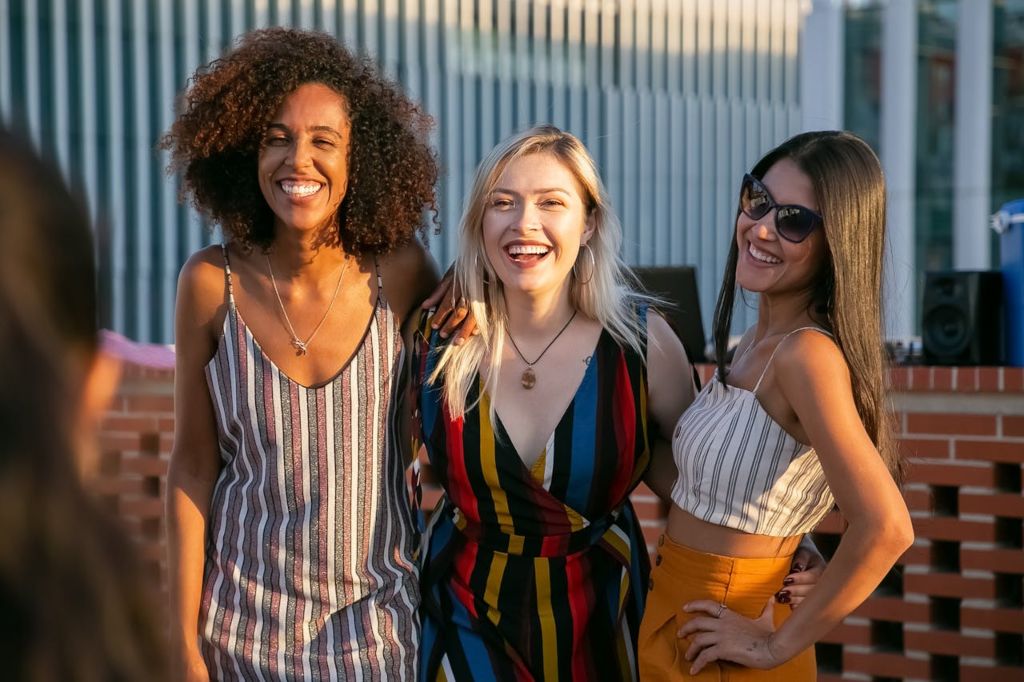 Women wearing summer chic clothes in summer sun