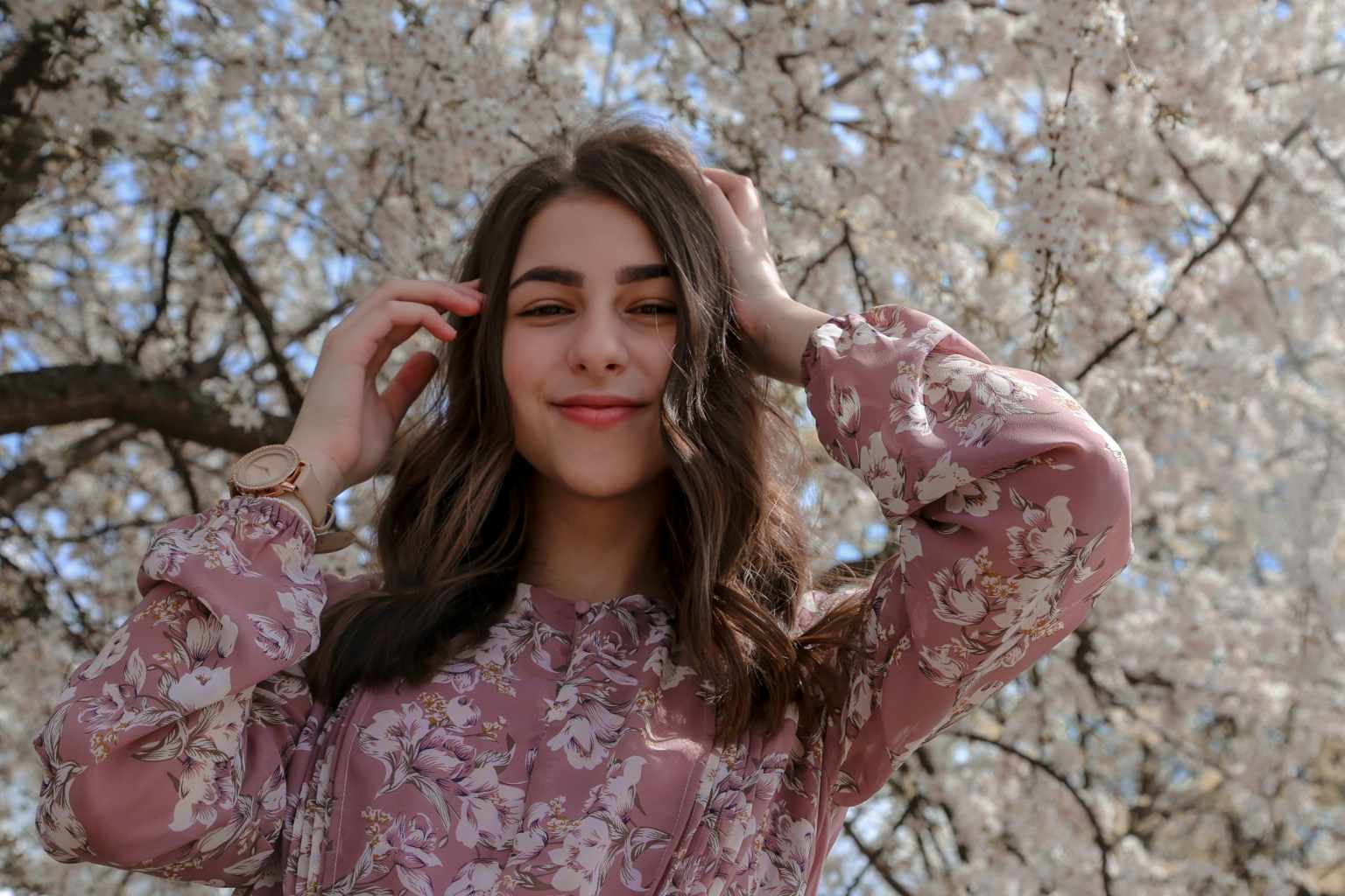Woman smiling and wearing a cute spring outfit