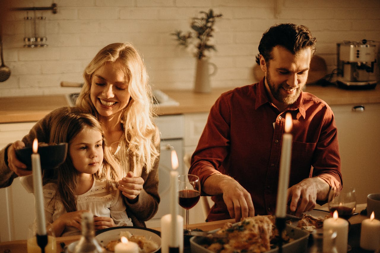 a family sitting at a table eating thanksgiving dinner