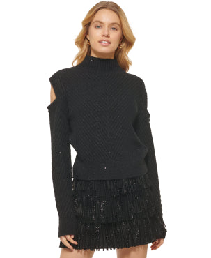 Woman modeling a black sweater from a DKNY outlet.