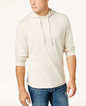 Man posing in cream-colored outlet hoodie