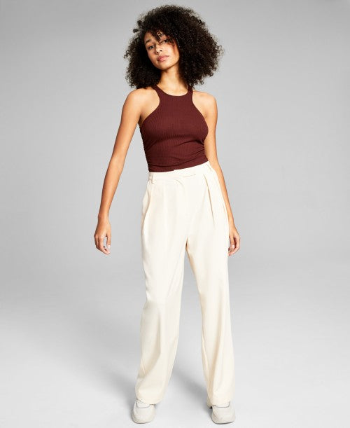 a woman wearing luxury pants and a top from an outlet online